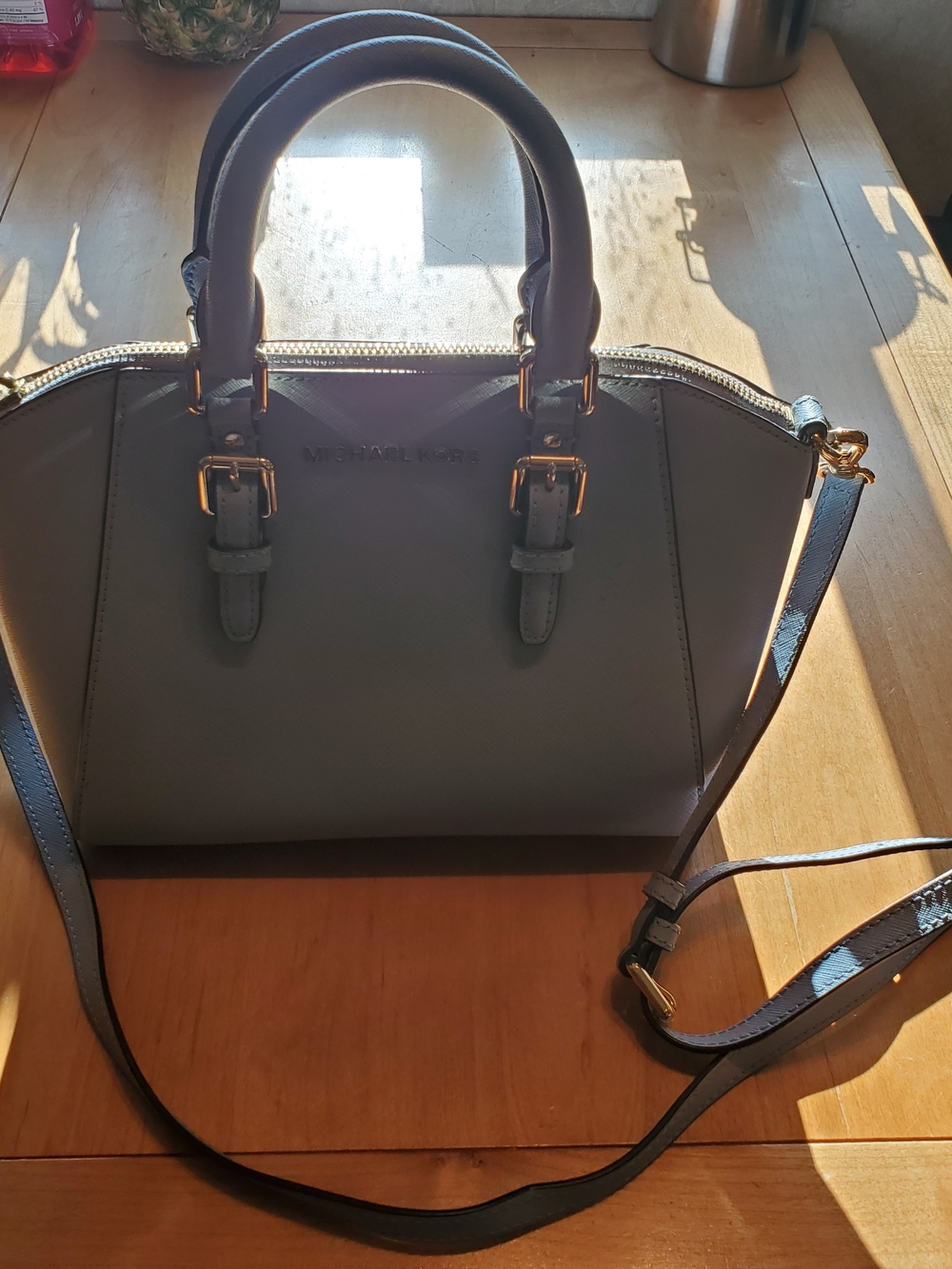 Michael Kors Handbag in Light Blue with Gold Hardware.